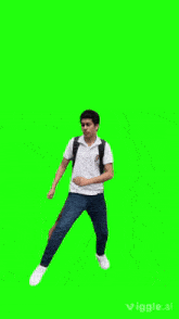 a boy with a backpack is jumping in the air