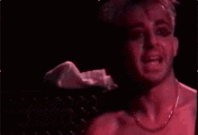 a close up of a man 's face in a red light