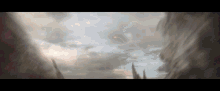 a rocket is flying through a cloudy sky above a building