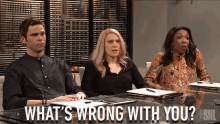 a group of people sitting at a table with the words " what 's wrong with you "