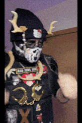 a person wearing a hello kitty hat and a skull face mask