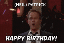 a man in a suit and tie is saying happy birthday