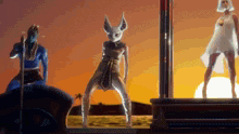 a woman in a cat mask is dancing with two other women