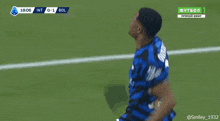 a soccer player in a blue jersey with the number 2 on the back