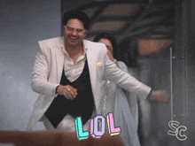a man in a white suit is standing next to a woman in a white dress with a lol sticker on the bottom