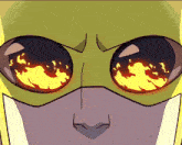 a close up of a cartoon character 's face with flames coming out of the eyes