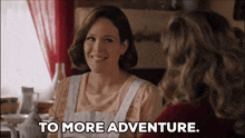 two women are sitting at a table and one of them is saying to more adventure