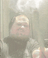 a man wearing a star wars shirt is smoking a joint