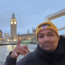 a man wearing a yellow hat that says london