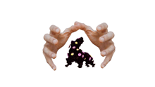 a person 's hands are holding a silhouette of a dog with purple eyes