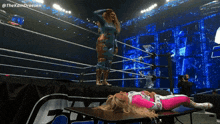 a woman laying on a table in a wrestling ring with the hashtag @thekamdreesen