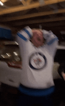 a blurry picture of a person wearing a jersey with a jets logo on it