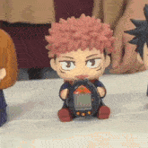 a person is holding a toy that looks like a cartoon character holding a device .