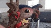a stuffed animal is sitting next to a hp laptop