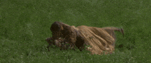 a person is laying in the grass with their legs crossed