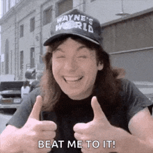 a man wearing a wayne 's world hat is giving two thumbs up and smiling .