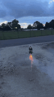 a flame is coming out of a faucet in a parking lot