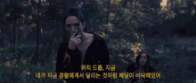 a man smoking a cigarette in the woods with a foreign language written below him