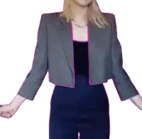 a woman in a gray jacket and blue pants is standing with her arms outstretched