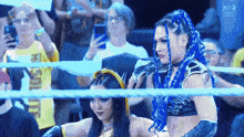 two women in a wrestling ring with a sign that says n