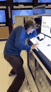 a man wearing headphones is standing in front of a display for beats studio pro