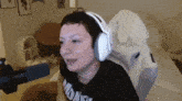 a woman wearing headphones and a t-shirt that says " midlife "