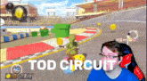 a man is playing a video game with the words tod circuit on the bottom