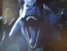 a close up of a monster 's face with its mouth wide open