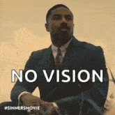 a man in a suit and tie is sitting in the grass with the words no vision behind him