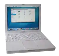 a white ibook g4 laptop is open to a screen