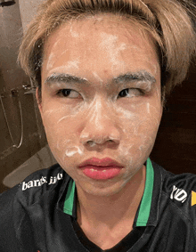 a young man with soap on his face wears a shirt that says baris jio