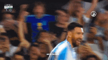 a soccer player is celebrating a goal in front of a crowd of people .
