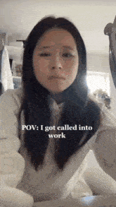 a woman is sitting at a table with the caption " pov : i got called into work "