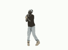 a man in a black shirt and blue hat is dancing on a white background .