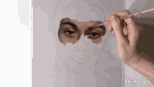 a person is painting a woman 's face with a brush and the words made in animatica on the bottom