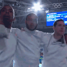 a group of men standing in front of a screen that says men 's sport team