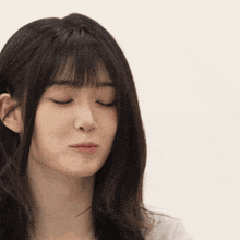 a close up of a woman making a funny face with her eyes closed