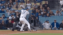 a baseball player named ohtani is swinging at a ball