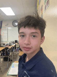 a boy in a classroom wearing a shirt that says ohio 's chiefs