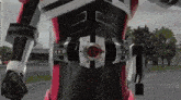 a video game character wearing a belt with a red circle on it