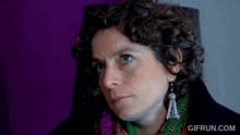 a close up of a woman 's face with the website gifrun.com visible in the corner