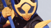 a close up of a cartoon character wearing a blue and yellow helmet .