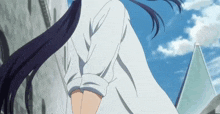a girl with long black hair and a white shirt is walking