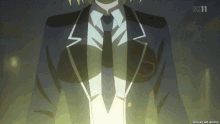 a man in a suit and tie is standing in front of a screen that says bs11