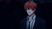 a man with red hair and a suit and tie is standing in the dark