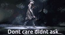 a man in a trench coat is walking in the dark with the words " do n't care didn't ask " below him