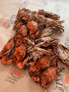 a bunch of crabs on a table with a place.com t-crab logo