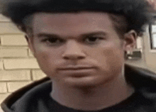 a close up of a man 's face with a very serious look on his face .