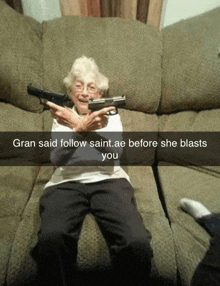 an elderly woman sitting on a couch holding a gun with a caption that says gran said follow saint.ae