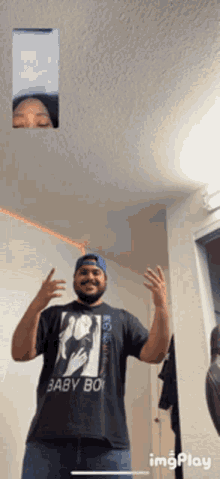 a man wearing a baby boy t-shirt is having a video call